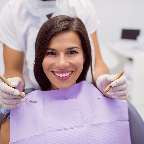 Patient smiling in the orthodontic chair during an exam