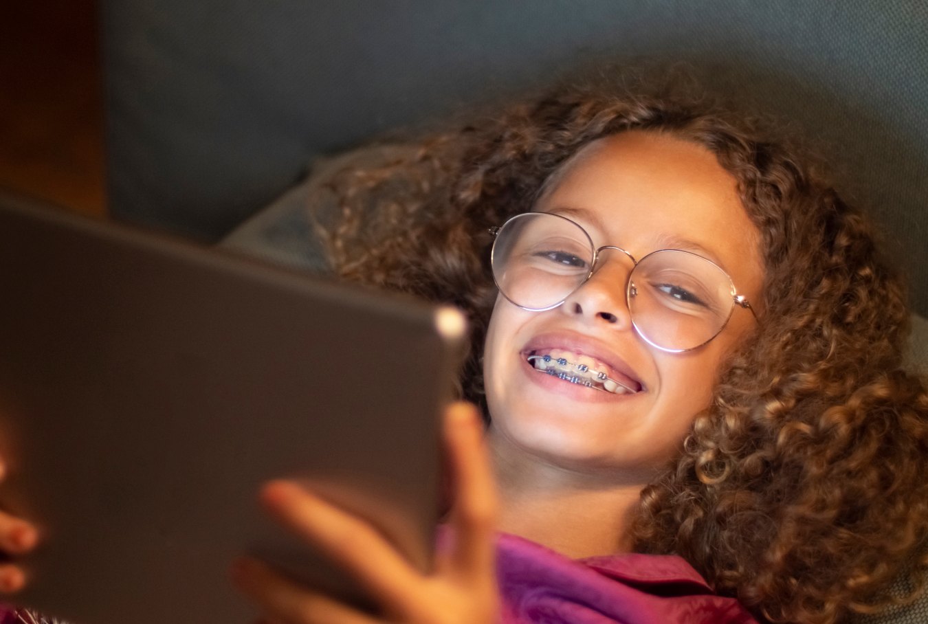 Teen girl with braces smiling and listening to music